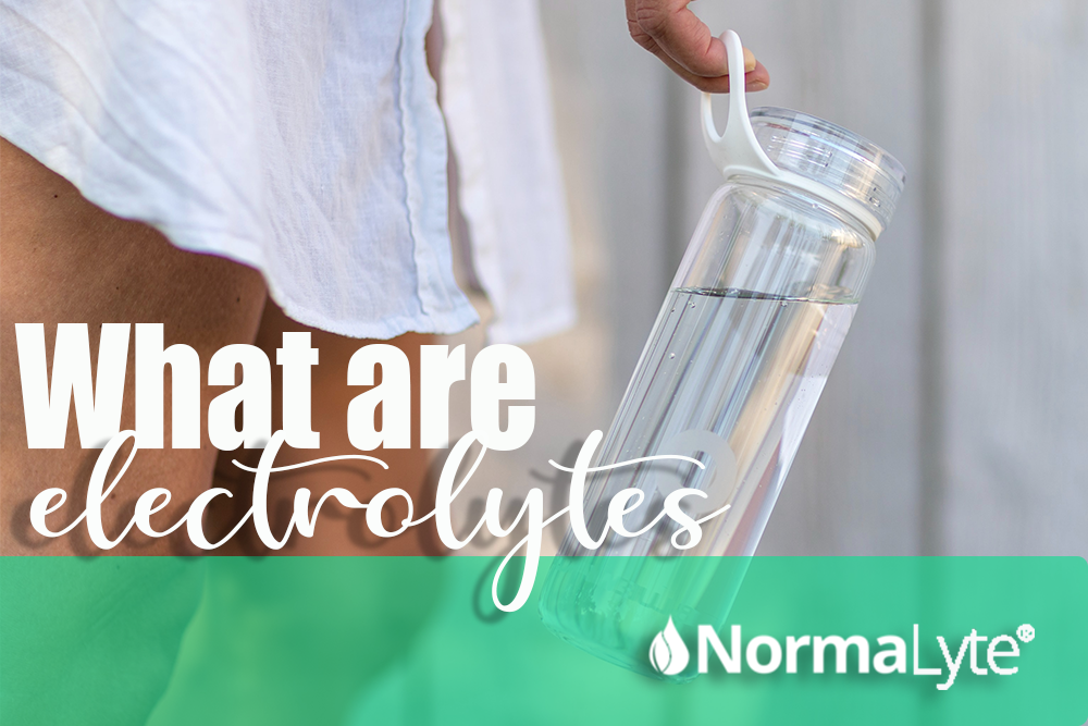 What are electrolytes? | NormaLyte ORS Oral Rehydration Salt Electrolyte Powder.  Image is of a woman who is holding a clear water bottle and wearing an oversized white dress shirt.  A teal bar at the bottom with the NormaLyte logo