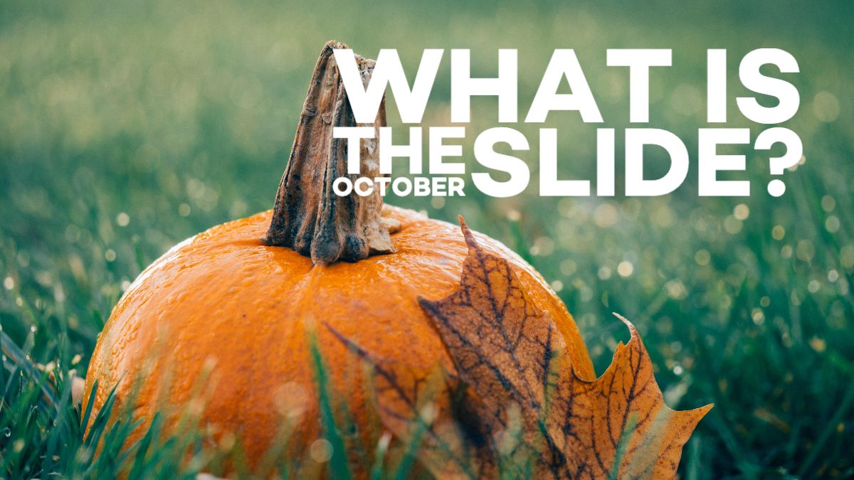 Image of a pumpkin sitting in the grass with a dried leaf.  The caption reads "What is the October slide?"