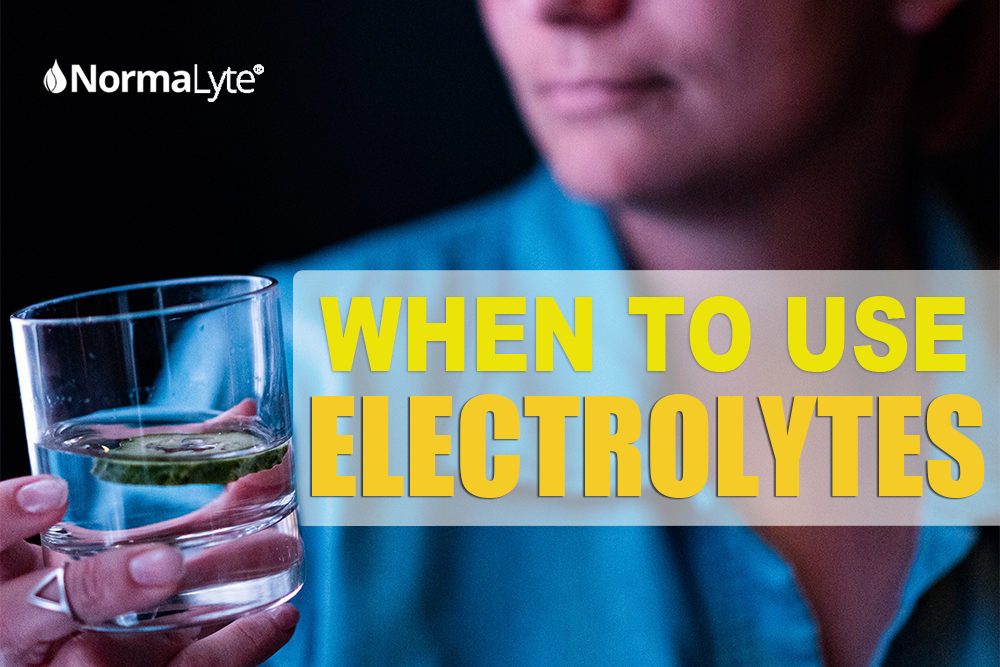 When to use electrolytes.  NormaLyte ORS Electrolyte powder image is a woman in a blue shirt holding a water glass filled with normalyte electrolyte oral rehydration therapy