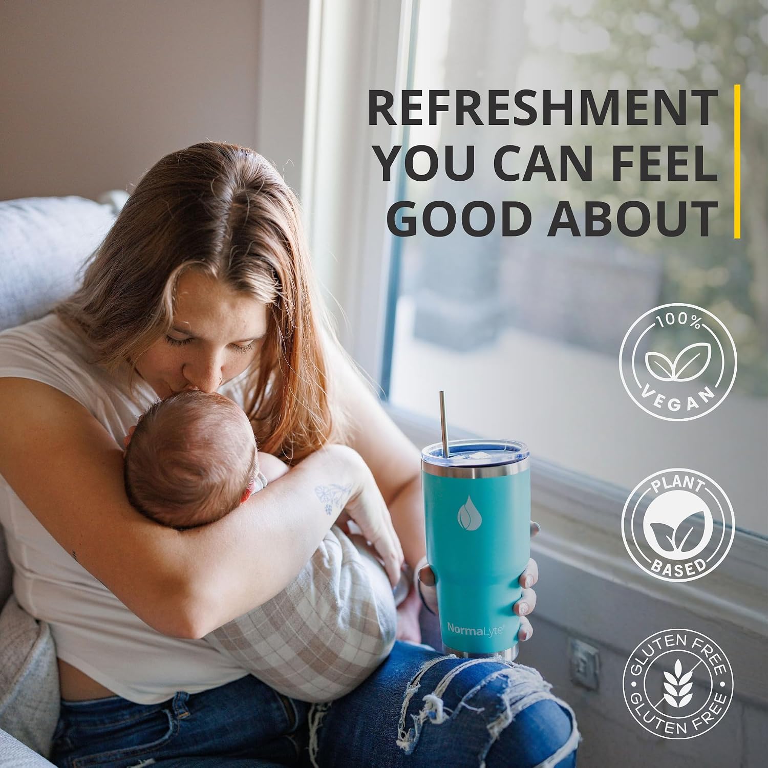 A woman holding and kissing her baby while holding a teal insulated tumbler with a straw in a bright indoor setting. Large text reads 'REFRESHMENT YOU CAN FEEL GOOD ABOUT' with badge icons for 100% vegan, plant based, gluten free, and gluten free.
