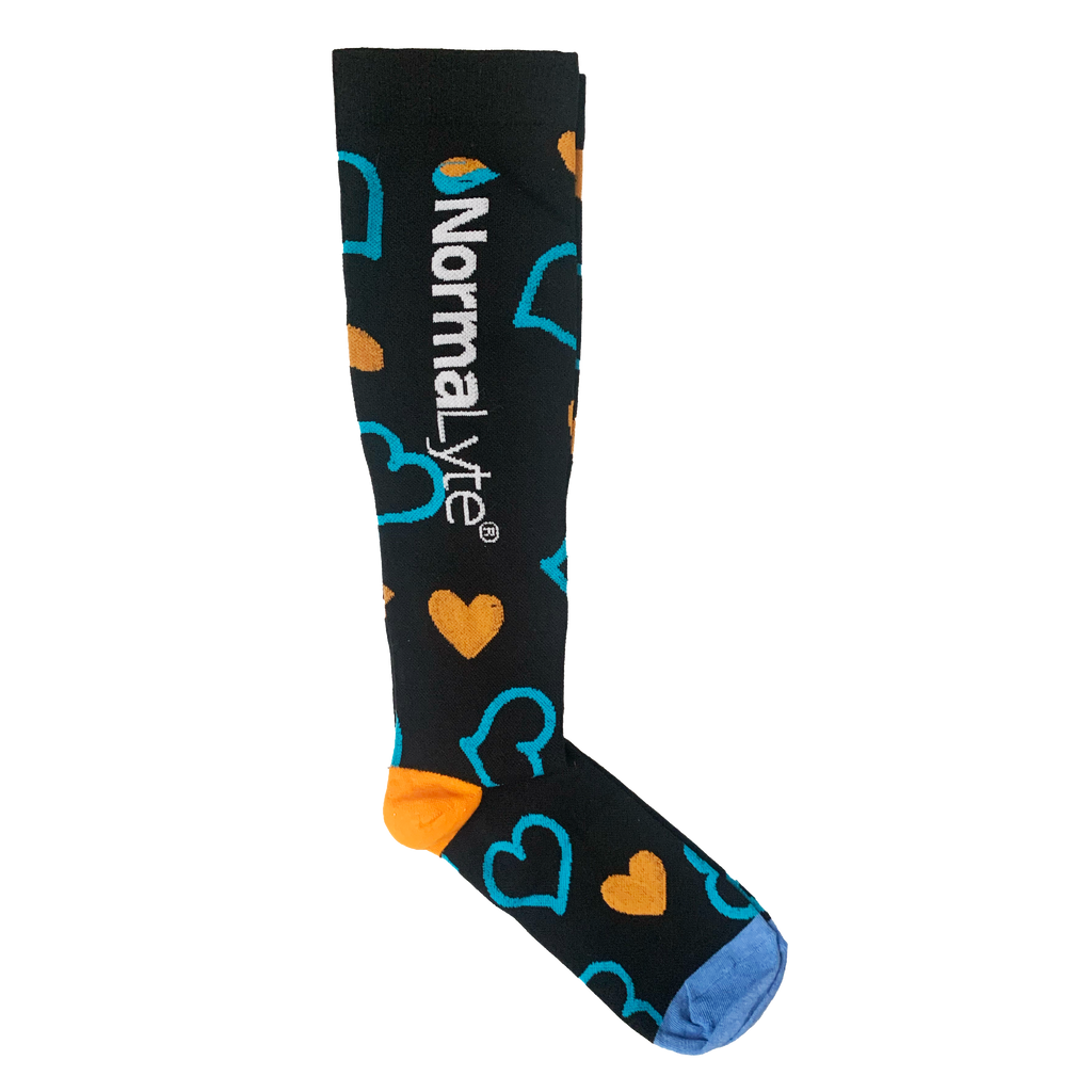 A single black NormaLyte graduated compression sock featuring a pattern of solid orange hearts and teal outline hearts, finished with an orange heel and light blue toe