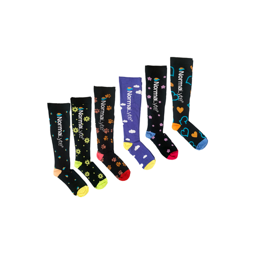 Six patterned NormaLyte graduated compression socks lined up to display the available style options for the 3-pack, featuring droplets, flowers, paw prints, clouds, stars, and hearts