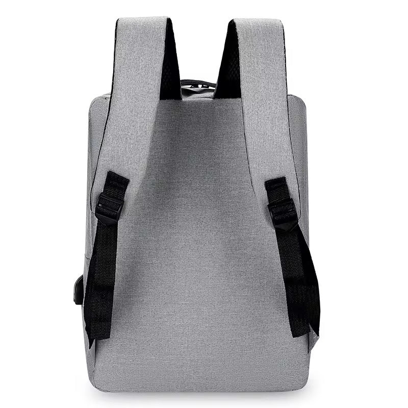 Back view of the gray NormaLyte durable everyday backpack for work and travel, showing the back panel and adjustable shoulder straps