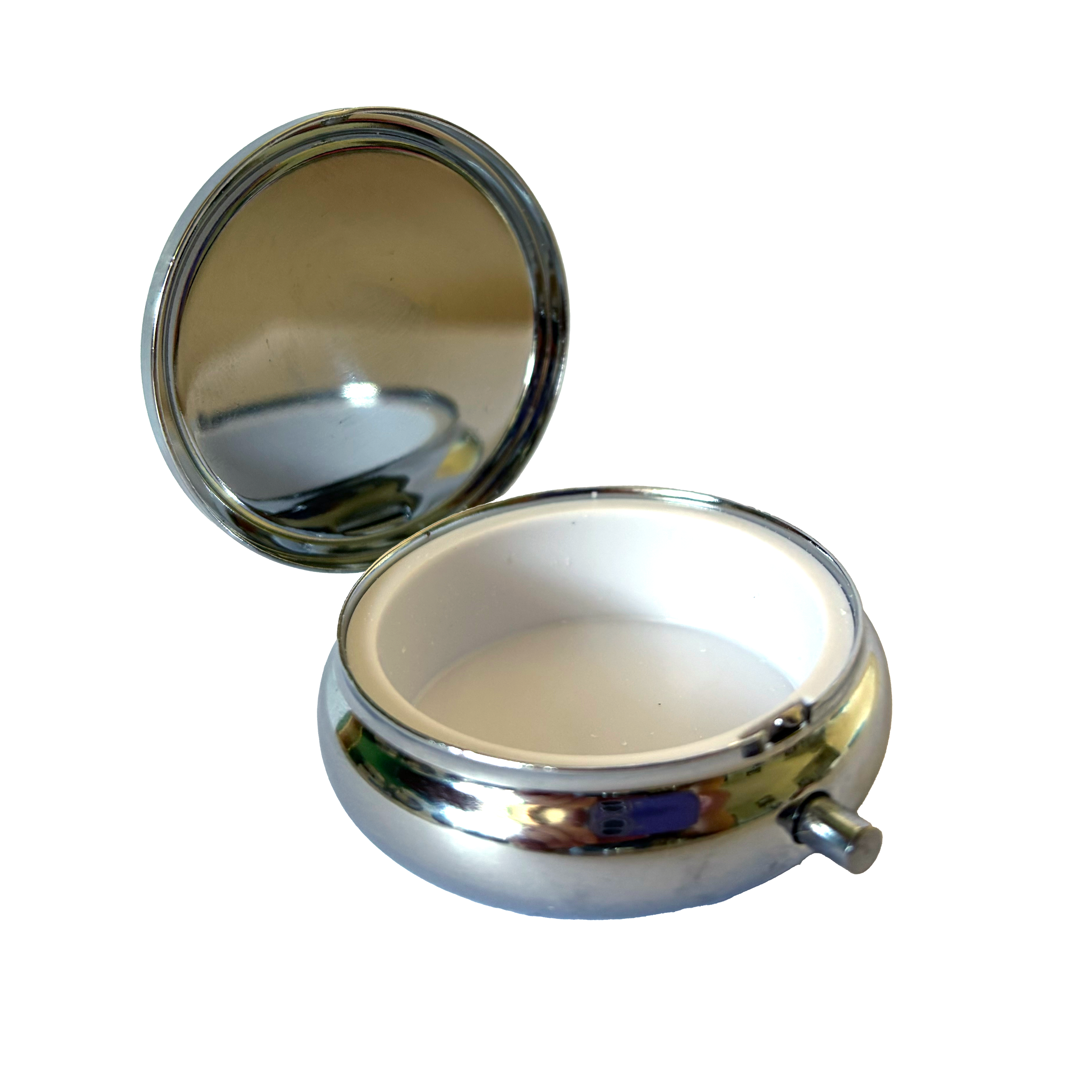 Open, empty NormaLyte Salty & Low on Spoons metal pill tin showing the white plastic interior compartment and reflective inner lid